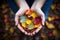 hands holding a collection of colorful autumn leaves,