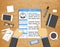 Hands holding CV profile over wooden desk with office objects around