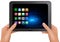 Hands holding digital tablet computer with icons.