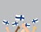 hands holding Finland flags