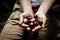 Hands holding handful of fresh Chestnuts