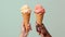 Hands holding icecream cones on Greenbackground