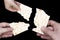 Hands holding matzah for jewish passover. An overhead photo of Jewish child, woman and men hands hold matza, leavened bread isolat