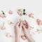 Hands holding natural soap bar with flowers on white background. Spa, Bath, Hygienic concept. Top View, Flatlay