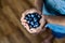 Hands holding organic fresh blueberries, summer harvest and healthy eating concept