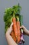 Hands holding organic fresh vegetables: pumpkin squash, carrots,