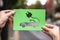 Hands Holding Paper With Cutout Electric Car