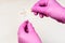 Hands holding pink acid litmus test and test tube