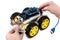 Hands holding programmable robotic car with obstacle avoidance and line following ability,  on white background with