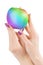 Hands holding rainbow colored apple isolated with clipping path