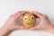 Hands holding raw potatoes with Googly eyes and smile. Vegetables with funny face