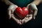 hands holding red heart, health care, love, organ donation, mindfulness, wellbeing, family insurance and CSR concept