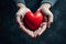 hands holding red heart, health care, love, organ donation, mindfulness, wellbeing, family insurance and CSR concept