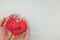 Hands holding a red heart tag with handwritten word local. Support, promote, buy, shop and love local business concept.