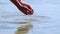 Hands holding river water on bright summer day