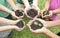 Hands holding sapling in soil surface