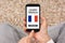 Hands holding smart phone with learn French concept on screen