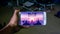 Hands holding a smartphone with Alto\'s Odyssey game on display screen