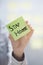 Hands holding sticky note with Stay Home text