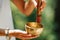 Hands Holding Tibetan Singing Bowl Outdoors