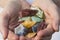 Hands holding various pieces of calcite