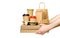 Hands holding various take-out food containers, pizza box, coffee cups in holder and paper bag isolated on white. Food