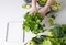 Hands holding vegetables. ingredients detox drink and notepad on  table.  Parsley in  hands of  girl