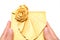 Hands holding a wrapped golden present box on white