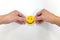 Hands holding a yellow smiley face on white background. Be positive and share happiness concept