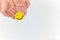 Hands holding a yellow smiling face on a white background. Be happy and share happiness concepts