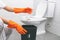 Hands holds the tissue paper for tipping into the trash in the toilet