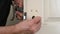 Hands insert a new spindle into a door lock barrel