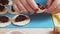 The hands of a Jewish woman mold Gomentashi cookies for the Purim holiday