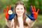 Hands of kid girl painted in Mongolia flag color. Focus on hands. July 10 National Flag Day. Independence Day of