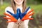 Hands of kid girl painted in Mongolia flag color. Focus on hands. July 10 National Flag Day. Independence Day of