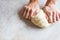 Hands knead dough