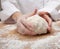 Hands kneading bread dough