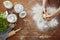 Hands kneading dough flour on wooden kitchen workspace