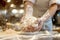 Hands kneading dough, rolling pin for dough, bakery and bakehouse