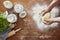 Hands kneading homemade pasta dough kitchen scene