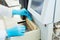 Hands of laboratory assistant loading sample tubes for coagulation test analysis