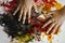 Hands of little Asian boy enjoying his abstract picture with colorful splatters.Education, school.