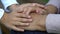 Hands of little girl carefully holding old wrinkled hands of granny, close up