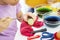 Hands of little girl dyeing eggs for Easter at home