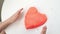 Hands little girl mold heart with kinetic sand. development of fine motor skills