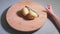 Hands of little girl peeling potatoes with peeler on wooden desk