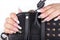 Hands with long artificial white and black french manicured nails and a handbag