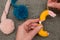 Hands Looping Yellow Yarn Around Pom-Pom Maker