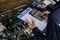 Hands of machinic man holding calculator and money, dollar banknotes to charge service and writing to the clipboard the checklist