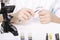 Hands with magnifier and tweezers at desk